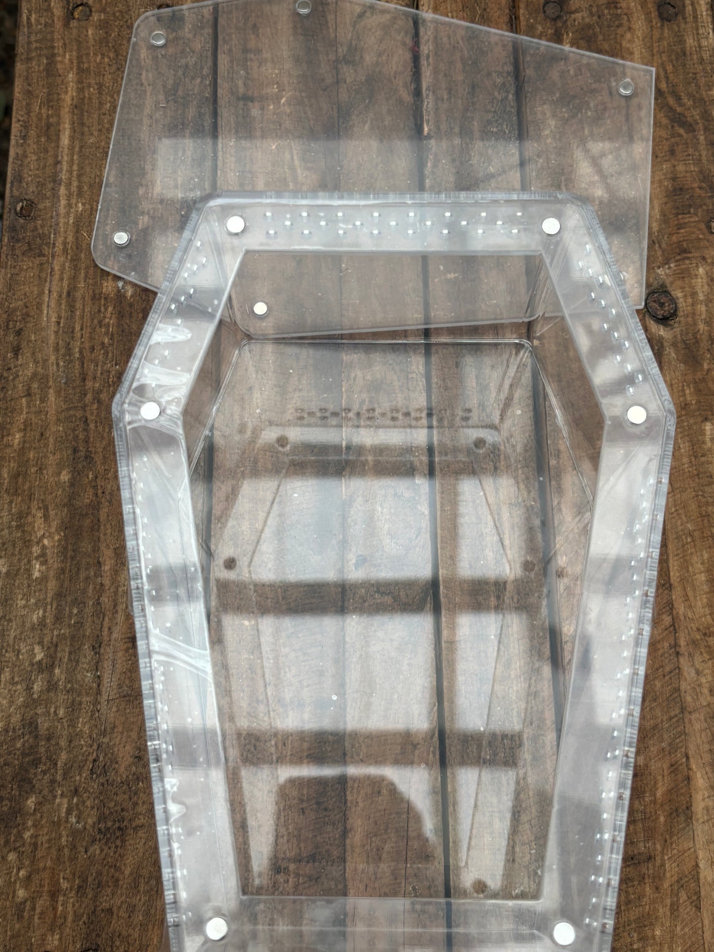 Coffin shaped enclosure 20cm longer x 14.5cm width at the widest points 10cm deep with strong magnetic lid.